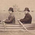 Three men in a fake rowing boat